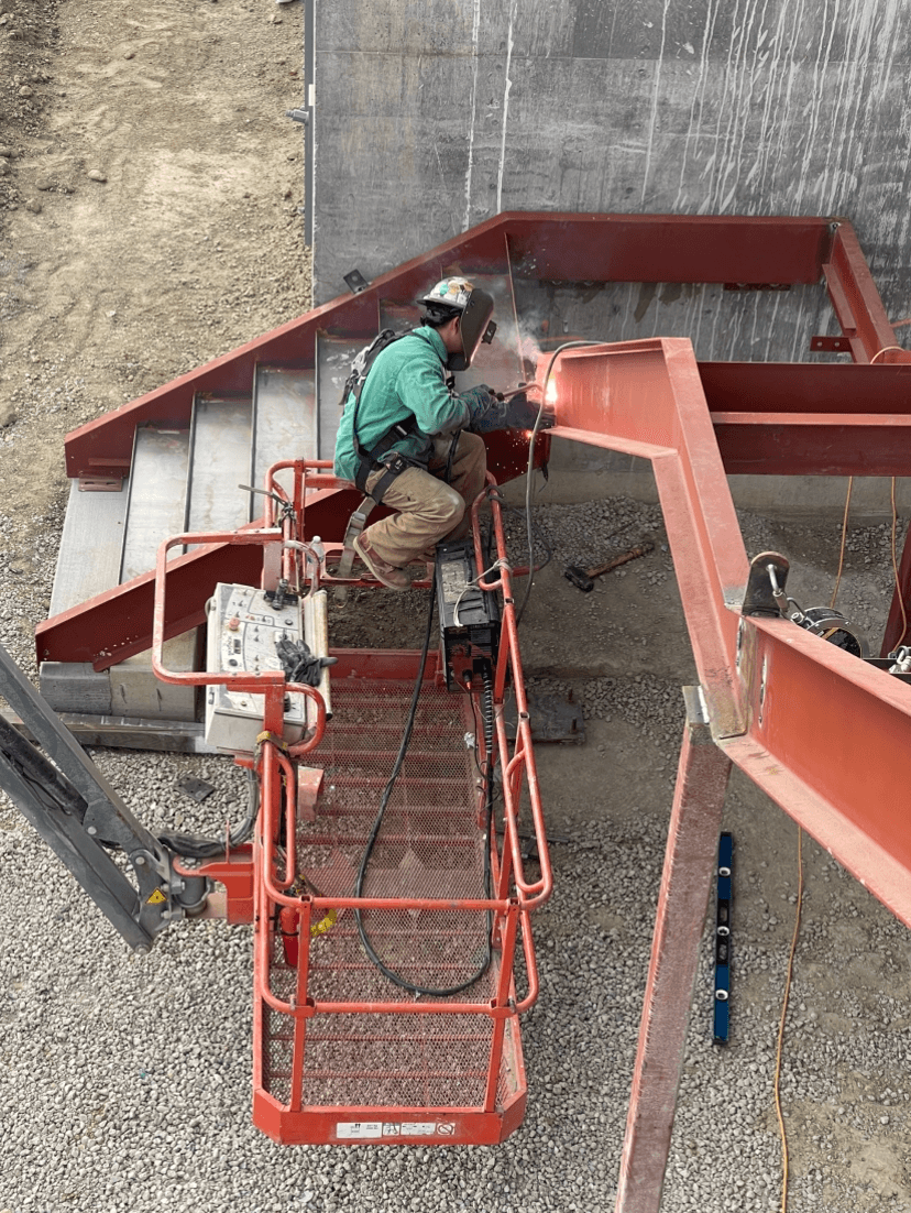 picture of a welder doing welding work on a commercial metal staircase